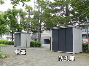 公園出入口を挟んで、左側に物置、右側に防災庫を設置